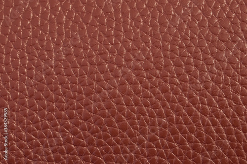 The texture of genuine leather. The texture of bovine skin. Macro photo. The skin is bovine. Relief skin texture. The surface of the product is made of genuine calf leather. Red abstract texture backg