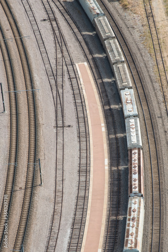 freight train on tracks going around a curve from above