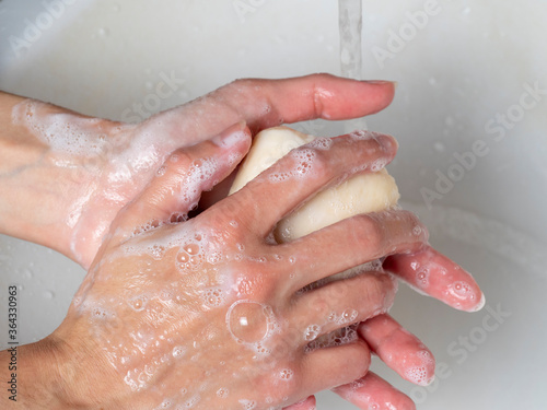 hand washing with soap. Concept of personal hygiene, countering viruses and microbes