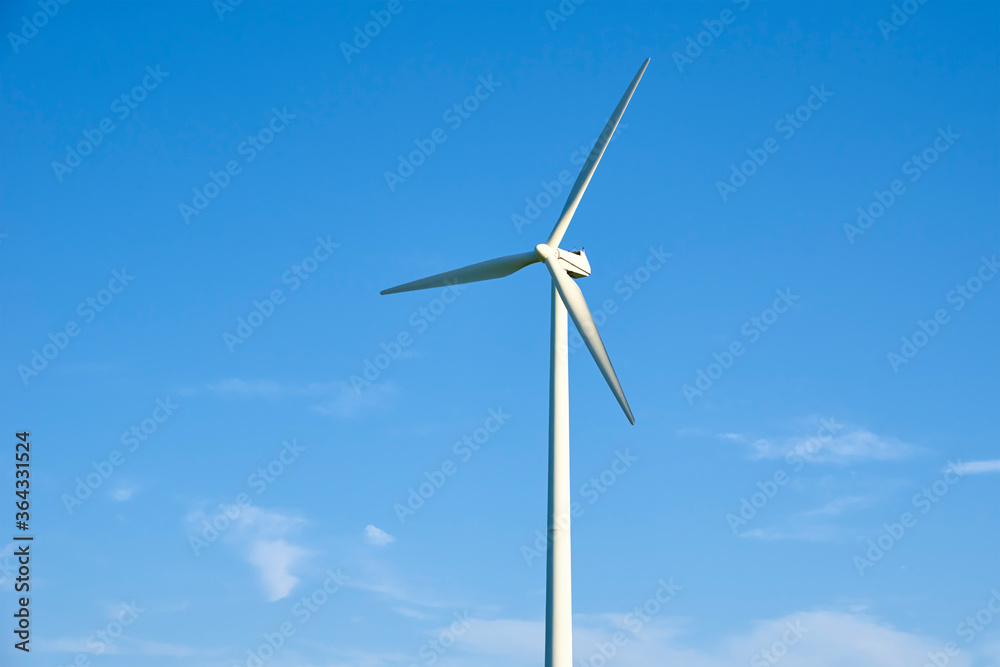 Wind turbine against blue sky. Wind power energy concept