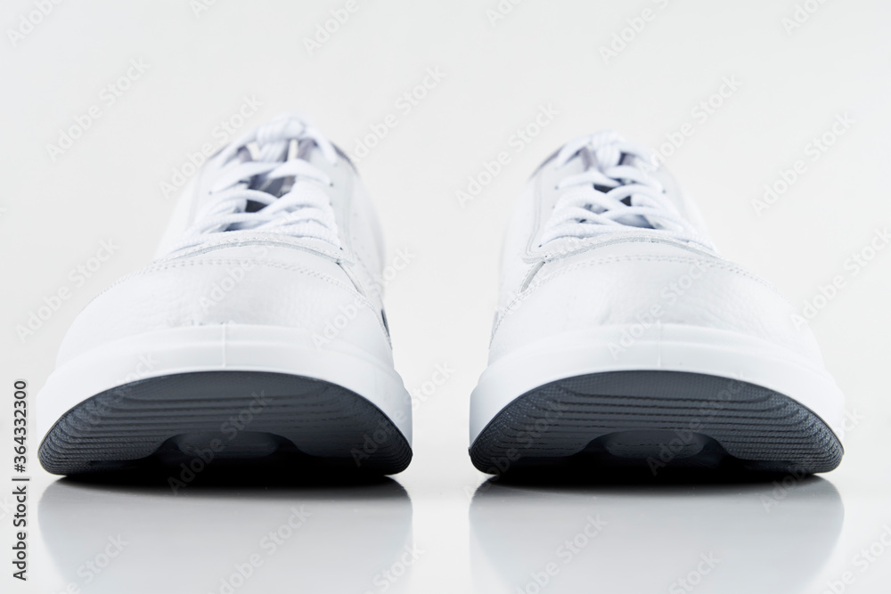 Pair of white male sneakers on white background isolated. Fashion stylish sport shoes, close up