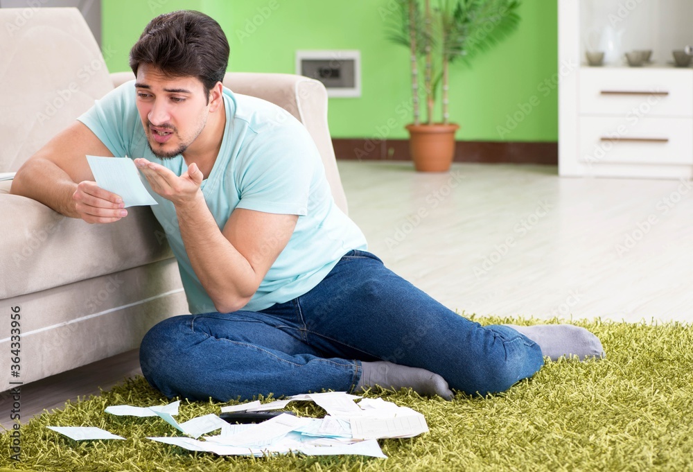 Young man struggling with personal finance and bills Young man struggling with personal finance and bills
