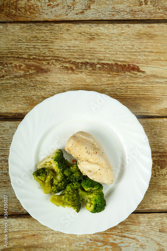 Boiled broccoli and chicken breast diet on a plate.