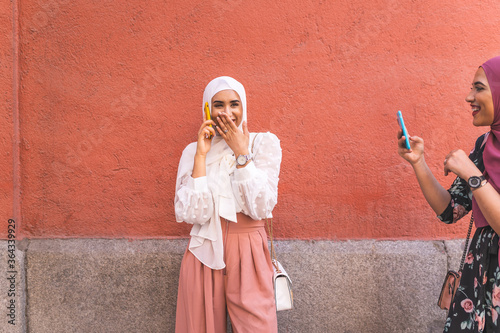 Beautiful Arab Girl Having Phone Call Outdoors. Lifestyle Concept. photo