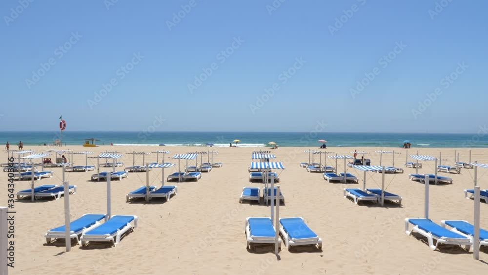 Empty sun loungers on beach during social isolation rules. Algarve. Static Empty sun loungers on beach during social isolation rules. Algarve. Static