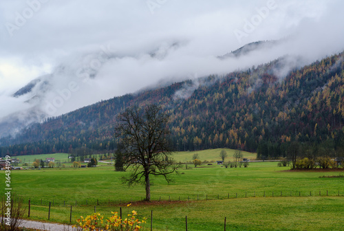 Cloudy and foggy autumn pre alps mountain countryside view. Peaceful picturesque traveling, seasonal, nature and countryside beauty concept scene. photo