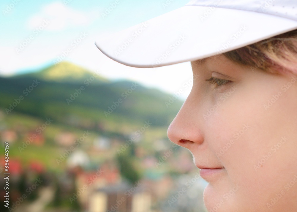 Fototapeta premium Girl's smiling face and beautiful mountain view