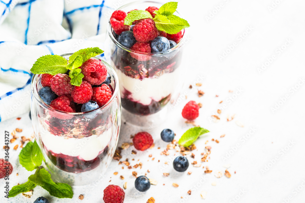 Parfait with granola, jam and fresh berries in the glass jar. Parfait with granola, jam and fresh berries in the glass jar.