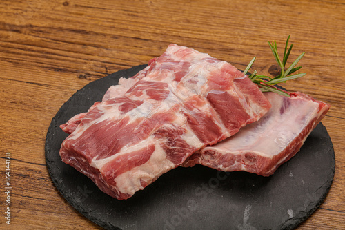 Raw pork ribs served rosemary