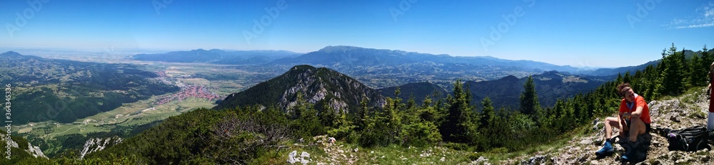 Mountain landscape in the summer with blue sky - panormic view  - hiker resting