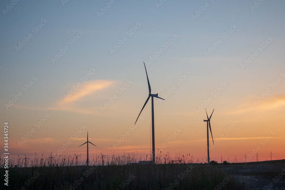 Wind generators turbines. Beautiful landscape at sunset. Green renewable energy Wind generators turbines. Beautiful landscape at sunset. Green renewable energy