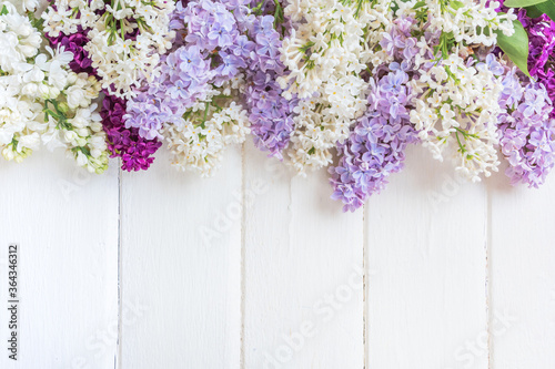 Lilac flowers branch on grey background with copyspace