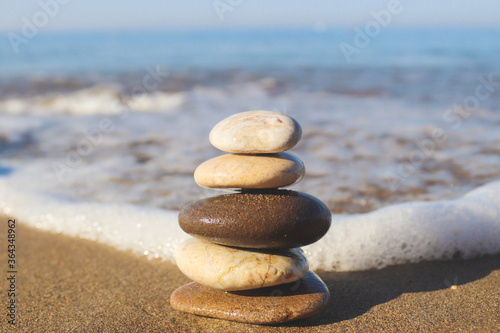 Stack of stones on sea background  copy space  selective focus. The concept of sea vacation  stability  harmony and life balance. Zen concept