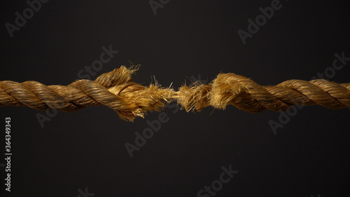A frayed rope about to snap under stress