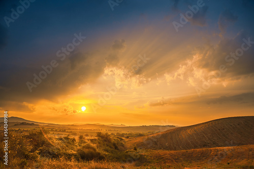 Magnificent summer sunset over Tuscany fields and hills