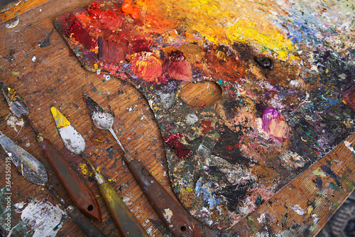 Artist's Palette and Palette Knives Covered in Paint