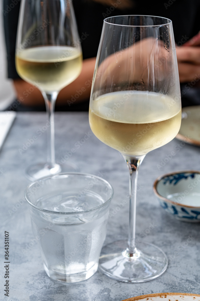 Drinking cold white wine with friends on outdoor terrace, summer vacation Drinking cold white wine with friends on outdoor terrace, summer vacation