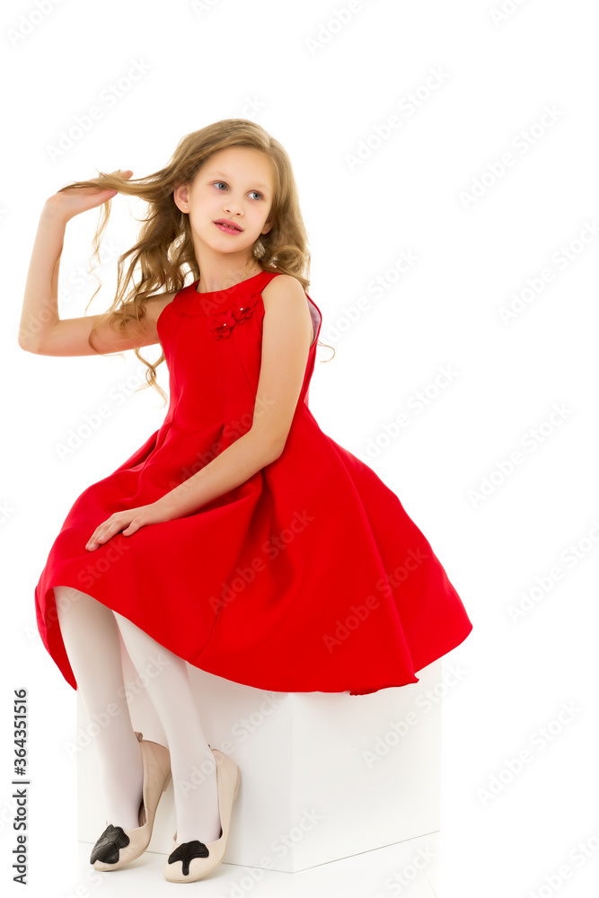 Beautiful Girl Wearing Nice Red Dress Sitting on White Cube Beautiful Girl Wearing Nice Red Dress Sitting on White Cube