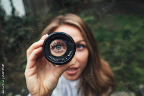 close up of blue eye through a lense blonde hair