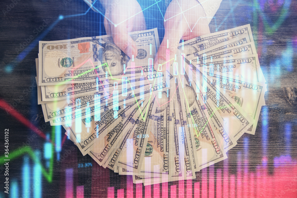 Multi exposure of financial graph drawing hologram and USA dollars bills and man hands. Analysis concept. Multi exposure of financial graph drawing hologram and USA dollars bills and man hands. Analysis concept.