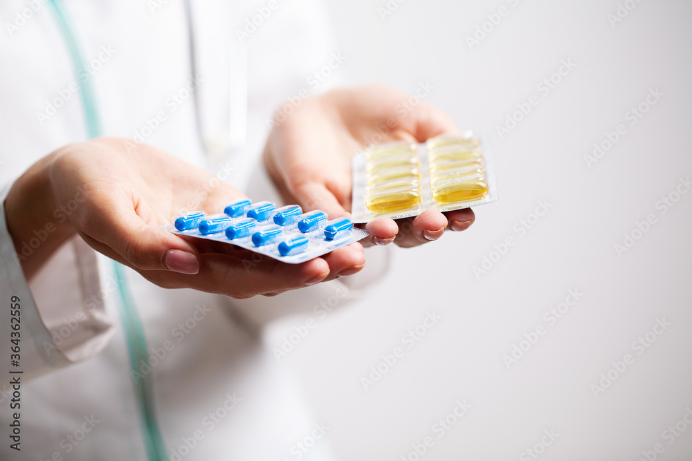 Doctor holds a pill for men's sexual health
