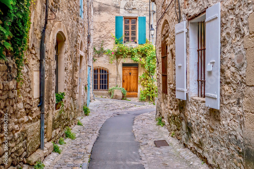 A quaint narrow lane running through the medieval area of Vaison la Romaine, a village in the Vaucluse region of Provence, France.