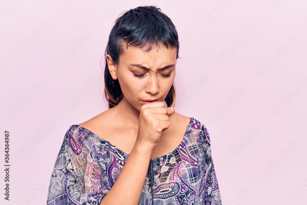 Young woman wearing casual clothes feeling unwell and coughing as symptom for cold or bronchitis. health care concept. Young woman wearing casual clothes feeling unwell and coughing as symptom for cold or bronchitis. health care concept.