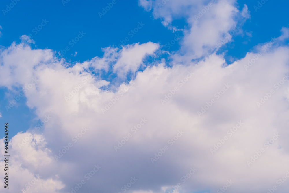 Cumulus clouds in blue sky.