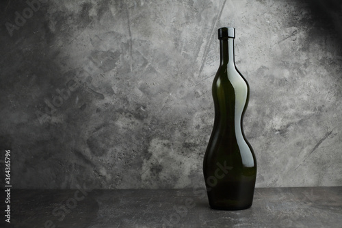 Wine bottle on a concrete background. Free space for inscription.