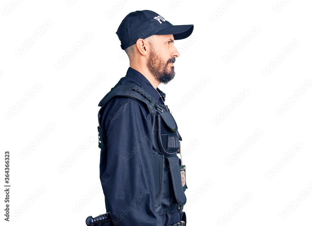 Young handsome man wearing police uniform looking to side, relax profile pose with natural face and confident smile. Young handsome man wearing police uniform looking to side, relax profile pose with natural face and confident smile.