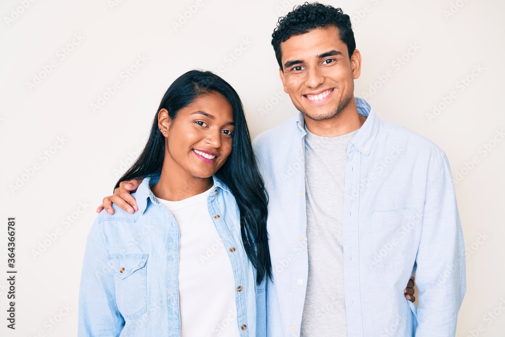 Beautiful latin young couple wearing casual clothes with a happy and cool smile on face. lucky person. Beautiful latin young couple wearing casual clothes with a happy and cool smile on face. lucky person.