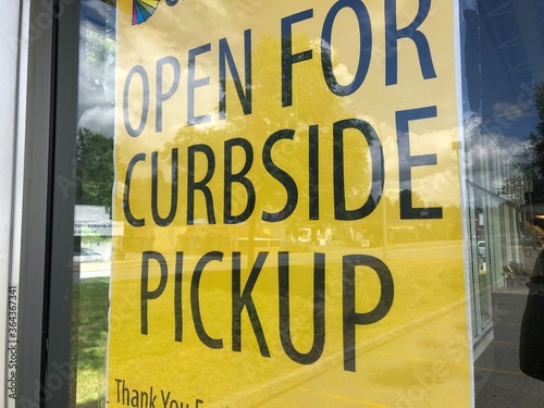 Yellow store sign for curbside pickup