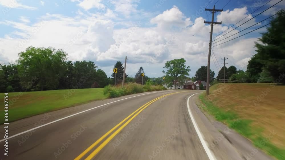 A forward driving view in the Pennsylvania countryside. Various homes and farmlands pass by. Pittsburgh suburbs. Part 1 of 3.  	