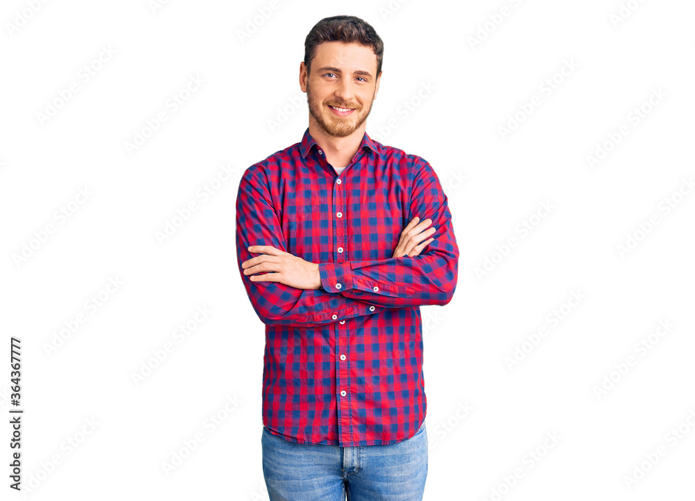 Fototapeta premium Handsome young man with bear wearing casual shirt happy face smiling with crossed arms looking at the camera. positive person.
