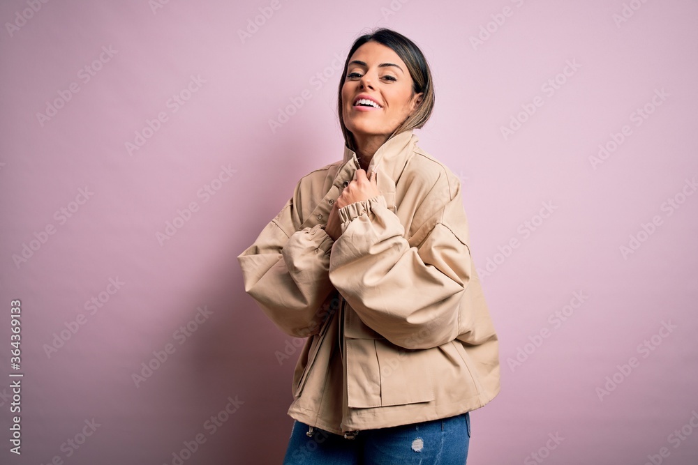 Young beautiful woman wearing fashion urban clothes, model wearing casual street style standing over pink background Young beautiful woman wearing fashion urban clothes, model wearing casual street style standing over pink background