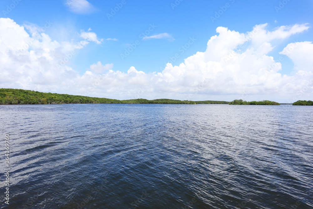 Ocean view from Biscayne National Park in Homestead, FL, Elliot Key in far distance from dock, Clear blue ocean water