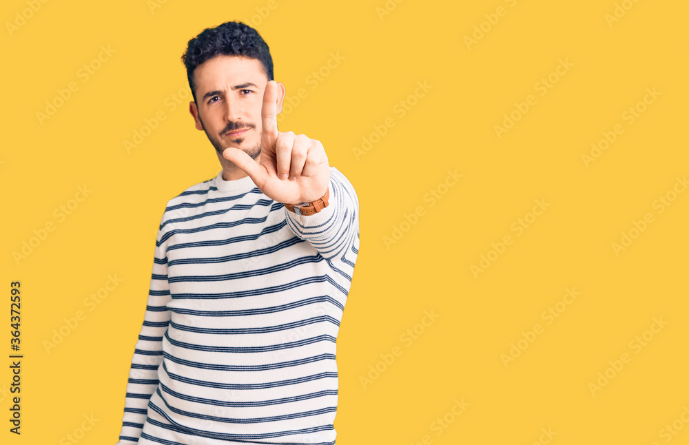 Young hispanic man wearing casual clothes pointing with finger up and angry expression, showing no gesture