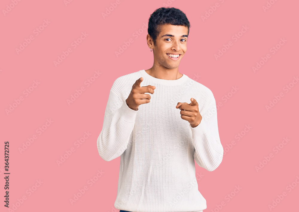 Young african amercian man wearing casual clothes pointing fingers to camera with happy and funny face. good energy and vibes. Young african amercian man wearing casual clothes pointing fingers to camera with happy and funny face. good energy and vibes.
