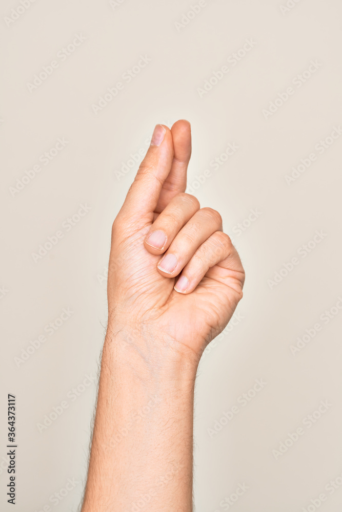 Hand of caucasian young man showing fingers over isolated white background holding blank space with thumb finger, business and advertising Hand of caucasian young man showing fingers over isolated white background holding blank space with thumb finger, business and advertising