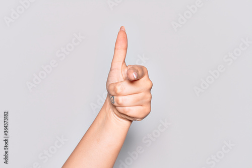 Hand of caucasian young woman pointing forefinger to the camera, choosing and indicating towards direction