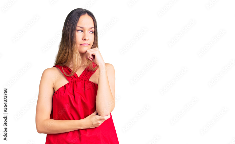 Beautiful brunette young woman wearing casual clothes with hand on chin thinking about question, pensive expression. smiling with thoughtful face. doubt concept. Beautiful brunette young woman wearing casual clothes with hand on chin thinking about question, pensive expression. smiling with thoughtful face. doubt concept.