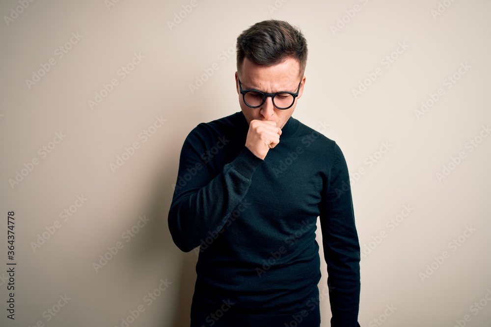 Fototapeta premium Young handsome caucasian man wearing glasses and casual sweater over isolated background feeling unwell and coughing as symptom for cold or bronchitis. Health care concept.