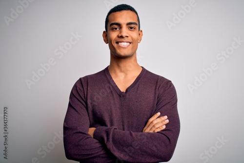 Young handsome african american man wearing casual sweater over white background happy face smiling with crossed arms looking at the camera. Positive person.