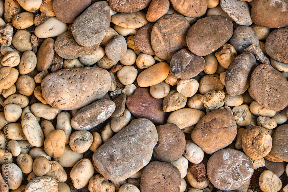 This unique photo shows many small stones from above which belong to a garden path in different structures and colors