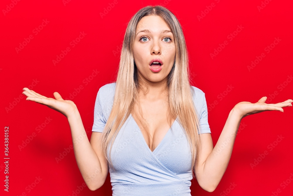 Young blonde woman wearing casual clothes clueless and confused with open arms, no idea and doubtful face. Young blonde woman wearing casual clothes clueless and confused with open arms, no idea and doubtful face.