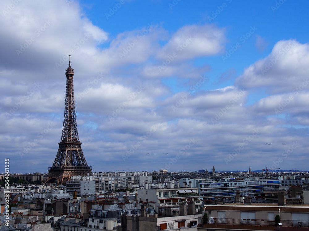 Paris skyline with an impressive Eiffel Tower in the pleasant blue sky.