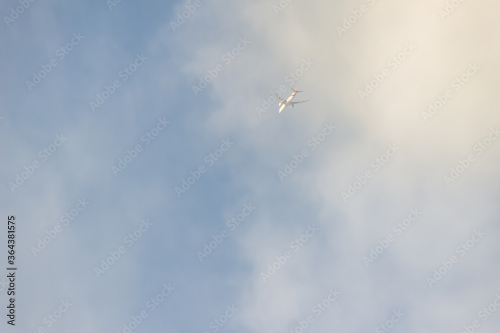 An airplane fading dissolve on sky and white cloud, looking up. An airplane fading dissolve on sky and white cloud, looking up.