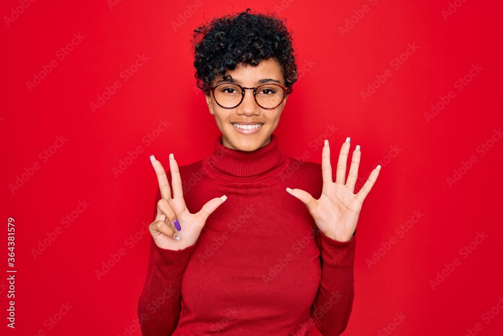 Young beautiful african american afro woman wearing turtleneck sweater and glasses showing and pointing up with fingers number eight while smiling confident and happy. Young beautiful african american afro woman wearing turtleneck sweater and glasses showing and pointing up with fingers number eight while smiling confident and happy.