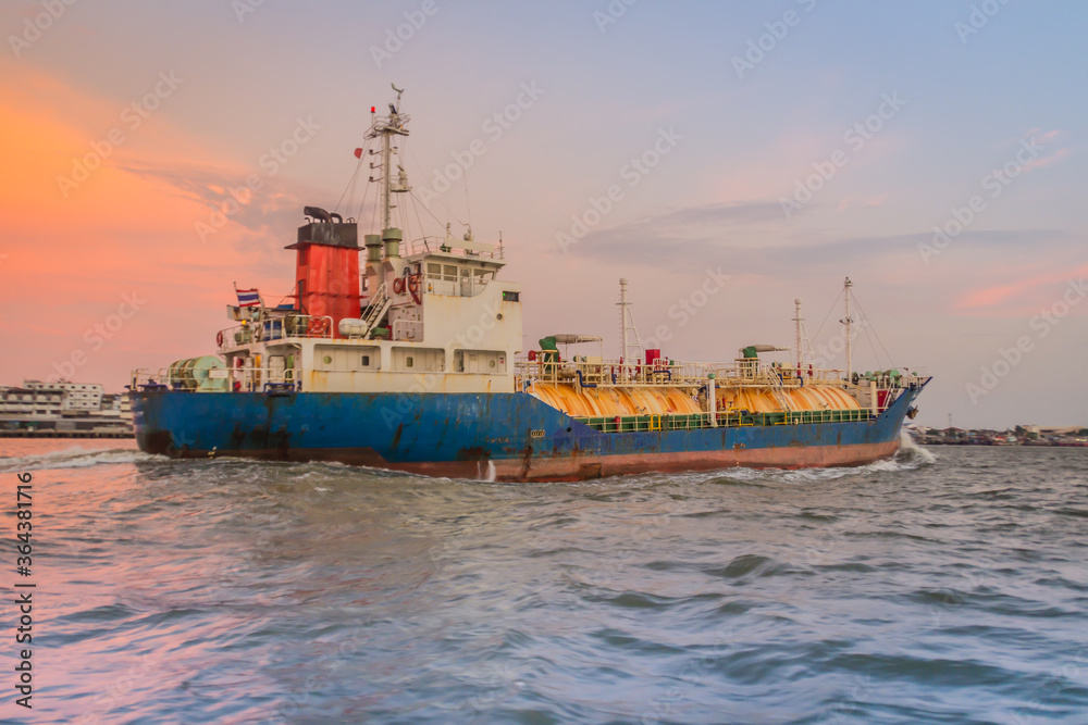 Massive container ship for import export and business logistic. Big cargo ship is leaving from Bangkok Port Authority of Thailand or Klong Toey port along Chao Phraya river in Bangkok,Thailand.