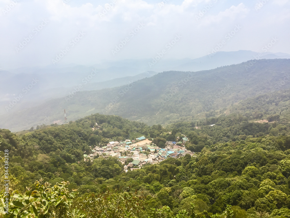 Panorama view of Doi Pui’s Hmong ethnic hill-tribe village, aerial view green forest on the mountain background. Doi Pui Hmong tribal village is located on Doi Suthep-Pui national park, Chiang Mai.